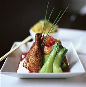 Chicken leg with pak choi and fruit