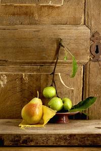 Apples and a pear in front of a wooden door