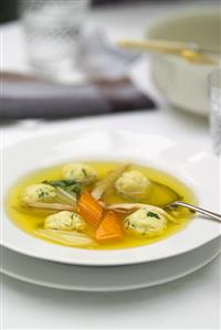 Chicken soup with kneidlach (matzo dumplings)