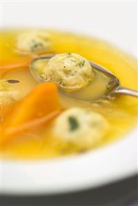 Chicken soup with kneidlach (matzo dumplings)