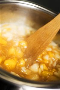 Apricot jam, stirring the fruit and sugar