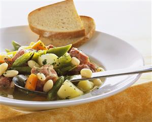 Cured pork with beans and vegetables