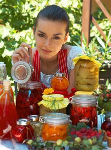 Woman tasting bottled fruit