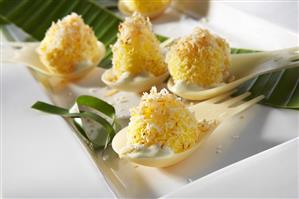 Sweet coconut balls with banana leaf