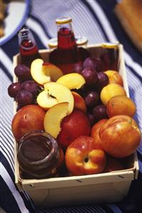 Fruit, fruit juice and acacia honey in a basket