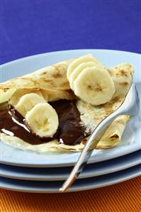 Pancake filled with banana and chocolate sauce