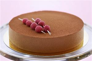 Chocolate mousse cake with skewered raspberries