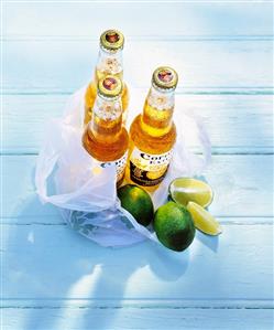 Three bottles of Corona (Mexican beer) with limes