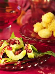 Cucumber with pomegranate seeds and beetroot leaves