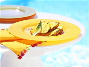 Pineapple slices on yellow plate