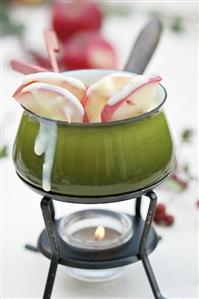 White chocolate fondue with cinnamon apples on sticks