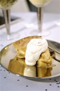 A piece of apple pie with whipped cream