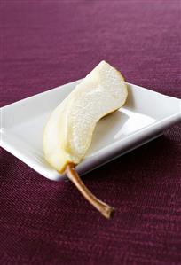 A quarter of a pear on a plate