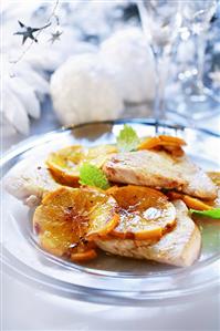 Turkey steaks with slices of orange