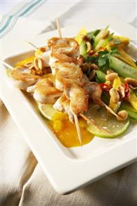 Satay on mango and cucumber salad