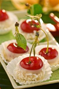 Chocolate-dipped cherries with grated coconut