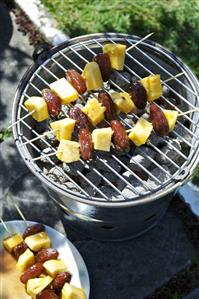 Pineapple and date kebabs on barbecue