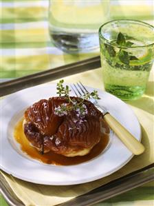 Pear Tarte Tatin with caramel sauce on a tray