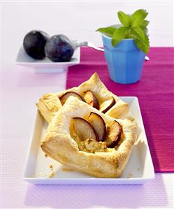 Two plum and ricotta puff pastry tarts