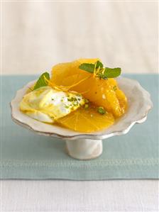 Dish of orange salad with pistachios and saffron cream