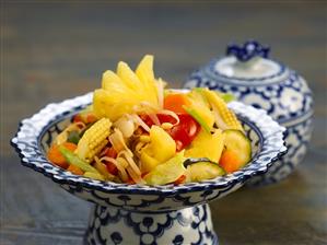 Fried vegetables with pineapple in a china bowl