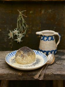 Yeast dumpling with custard on a wooden bench