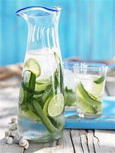 Carafe and glass of fresh limeade out of doors