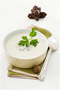 Jerusalem artichoke soup with parsley in a bowl