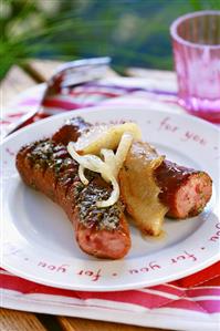 Fried sausages with apple and onion slices