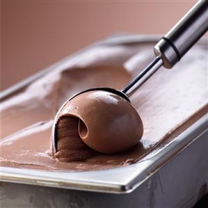 Chocolate ice cream in ice cream container with ice cream scoop