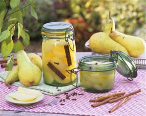 Bottled pears in preserving jars, fresh pears, spices