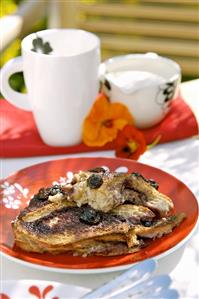 Bread and butter pudding with blueberries on a plate