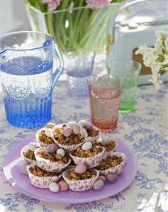 Small cakes with chocolate Easter eggs in paper cases