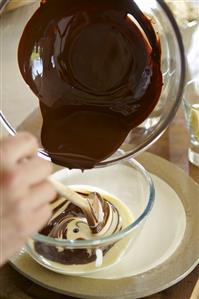 Mixing melted chocolate and custard in a bowl