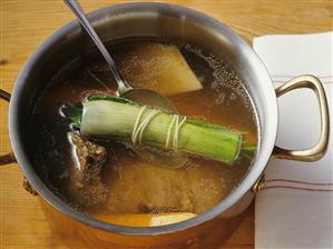 Stewing meat, vegetables and bouquet garni in a pan