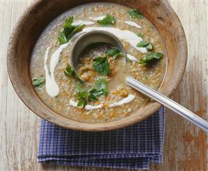 Green spelt soup in a wooden bowl