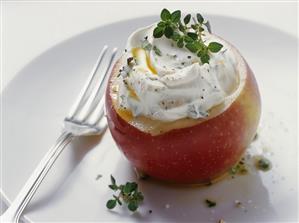 Herb soft cheese in a hollowed-out apple