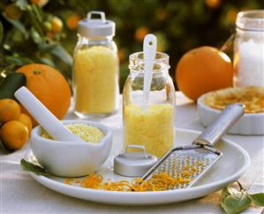 Home-made orange sugar with mortar, pestle & grater out of doors