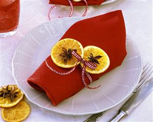 Napkin decorated with dried orange slices and star anise