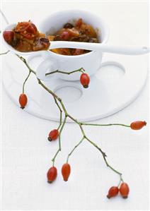 Rose hip and quince chutney in a cup with spoon