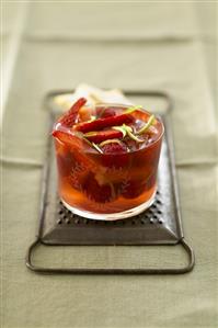 Strawberries and raspberries in jelly in a glass