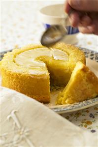 Soaking pineapple cake (a piece cut) with sugar syrup