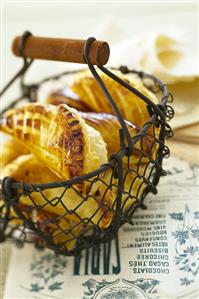 Apple turnovers made with puff pastry in a wire basket