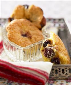 Three small cherry cakes on a tray