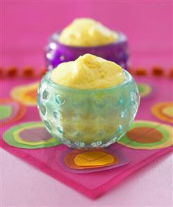 Mango mousse in two round glass dishes