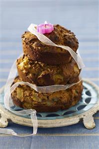 Three chocolate muffins piled up to form a birthday cake