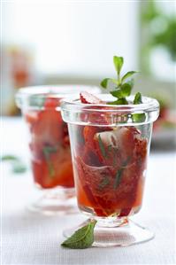 Marinated strawberries with mint in two glasses