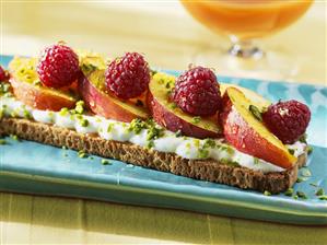 Yoghurt, peach, raspberries and honey on toasted bread