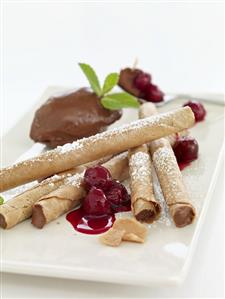 Mousse au chocolat with wafer rolls and cherries