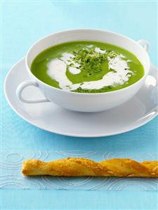 Pea soup with horseradish cream and puff pastry stick